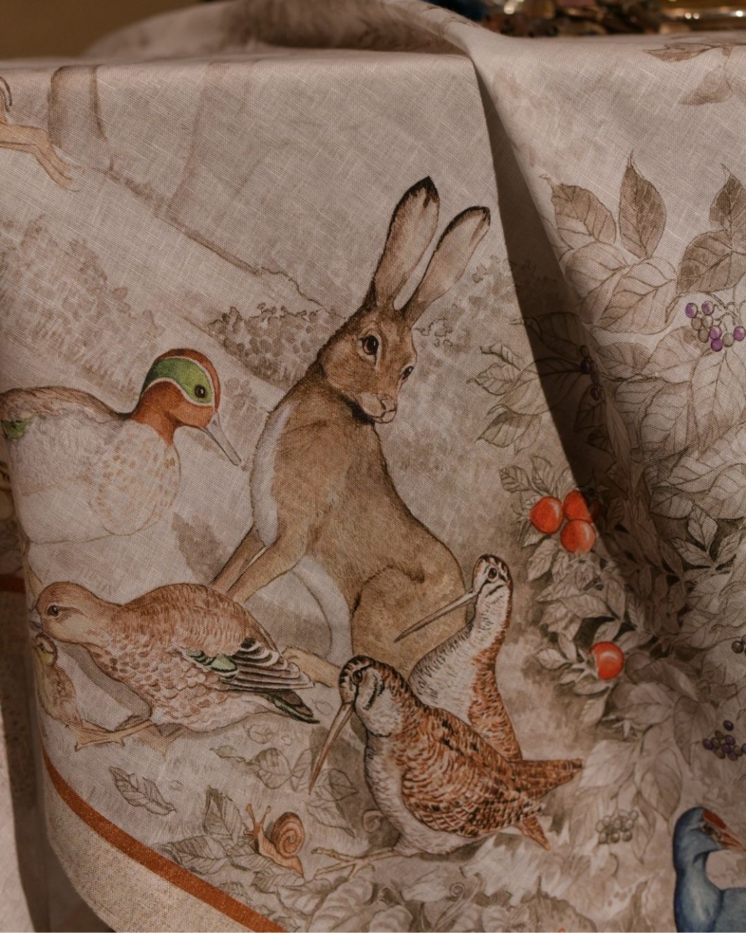 Close-up of Norma linen tablecloth with hare and birds