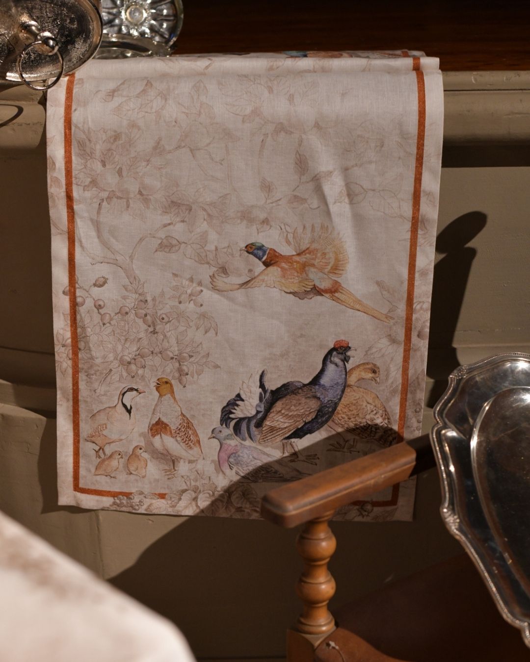 Norma linen table runner styled with antique tableware